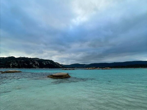 Escape to a serene coastal haven with turquoise waters and rugged coastline.