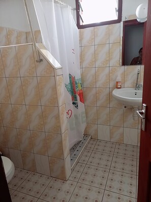 A bathroom with a shower, a sink, and a toilet. - Stay. Plus Darad Homes Diani (Ukunda)
