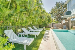 A poolside area with lounge chairs and a swimming pool.