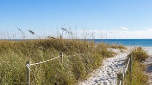 A sandy beach path with a rope barrier, leading to the ocean. - Point Three + Pool, Bikes, Nearby Beach & Sunroom (Panama City Beach)