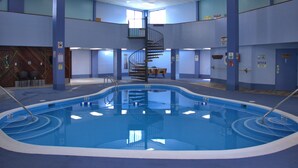 An indoor swimming pool with a central staircase, surrounded by walls with safety signs and a wooden panel wall on one side. - 4308  Hot tub, sauna & more resort amenities  Altitude Adjustment (Beech Mountain)