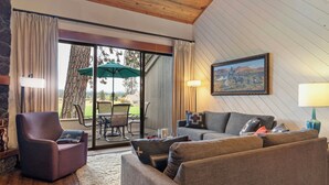 Una sala acogedora con sofá, sillón y comedor con mesa y sillas.