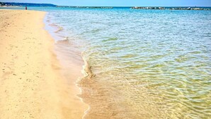 A beach scene with clear water and a sandy shore. - 2-bed Apartment in Abruzzo, Italy 15 Minute to sea (Paglieta)
