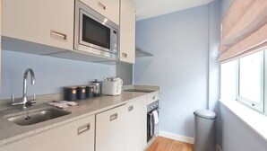A compact kitchen with a microwave, sink, and toaster. - Prince Street Studio 2 - Hopewell (Bristol)