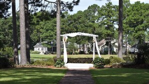 A gazebo in a well-maintained garden with a brick pathway leading to it. - Ground Floor Studio 2503L in Brunswick Plantation Resort with Family Friendly Outdoor Pools Onsite by RedAwning (Calabash)