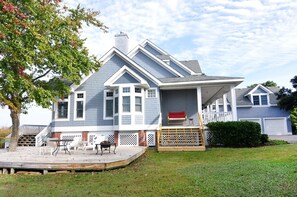 A two-story house with a covered porch, a small deck, and a garage. - Live Oak Landing: Shared Pool, Spa, Great Views! (Corolla)