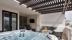 A rooftop terrace with a hot tub, outdoor seating, and a fire feature. - Desert Color Lake House: Desert Color Lagoon + Beaches (St. George)