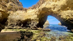 A natural rock formation with a clear water passage through it. - Green and Blue View Apartment Albufeira by Rentals in Algarve (Albufeira)