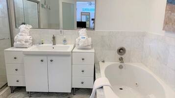 Bathtub, hair dryer, towels, soap