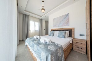 A bedroom with a bed, a nightstand, a wooden headboard, a ceiling light, and a window with curtains.
