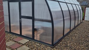 A large greenhouse structure with a curved roof and multiple transparent panels. - Apartment (Brunsbüttel)