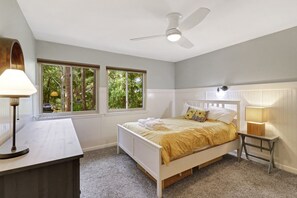A bedroom with a bed, a desk, a chair, a lamp, and a ceiling fan. - Pet friendly, 2 golf carts included - 854 Marsh Dunes (Fripp Island)
