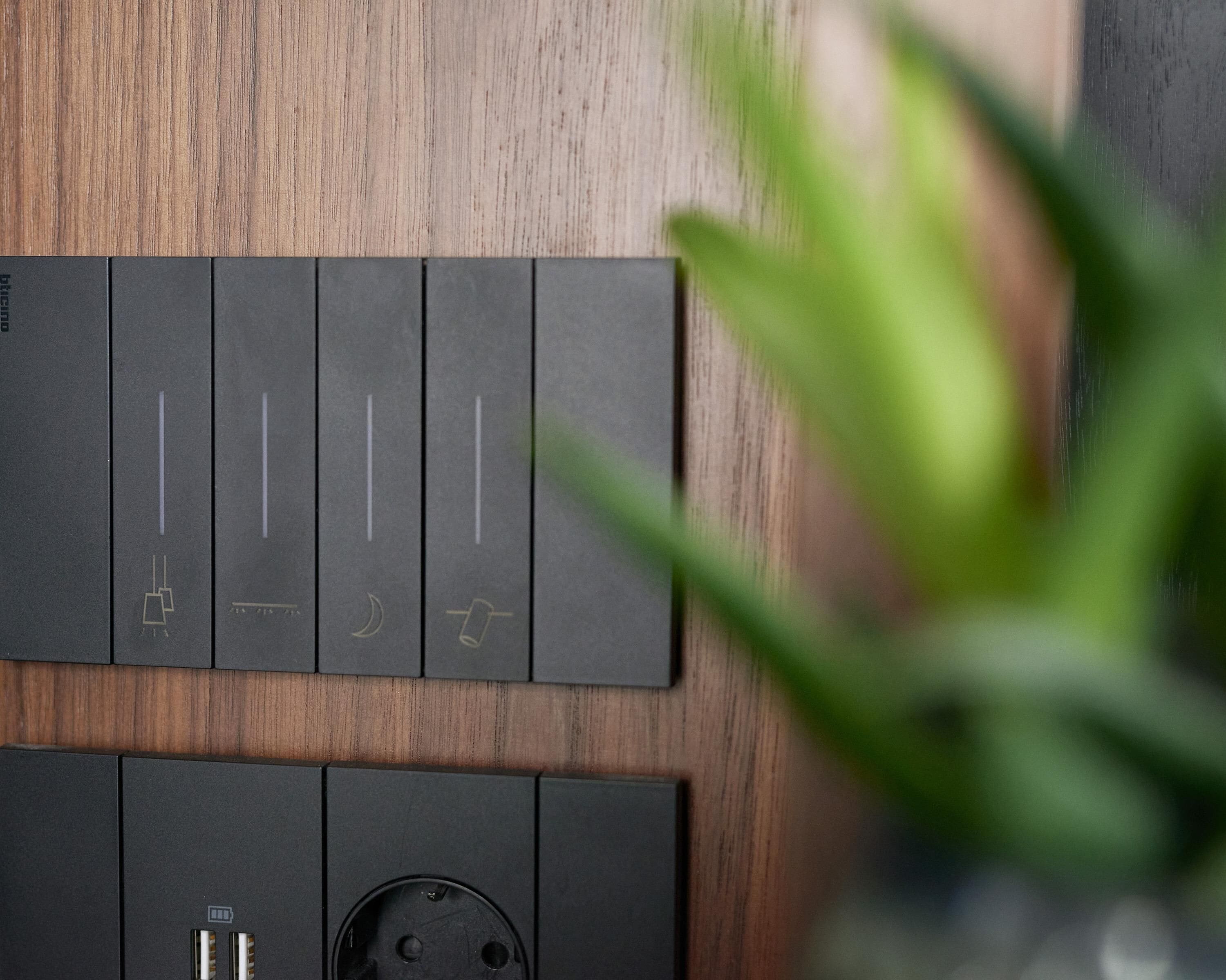 A control panel with four switches, each marked with a different symbol, and a power outlet below.