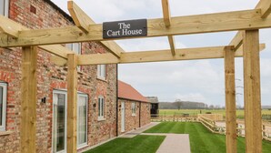 A brick building with a sign reading "The Cart House." - The Cart House (York)