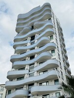 Un edificio de varios pisos con balcones en cada planta.