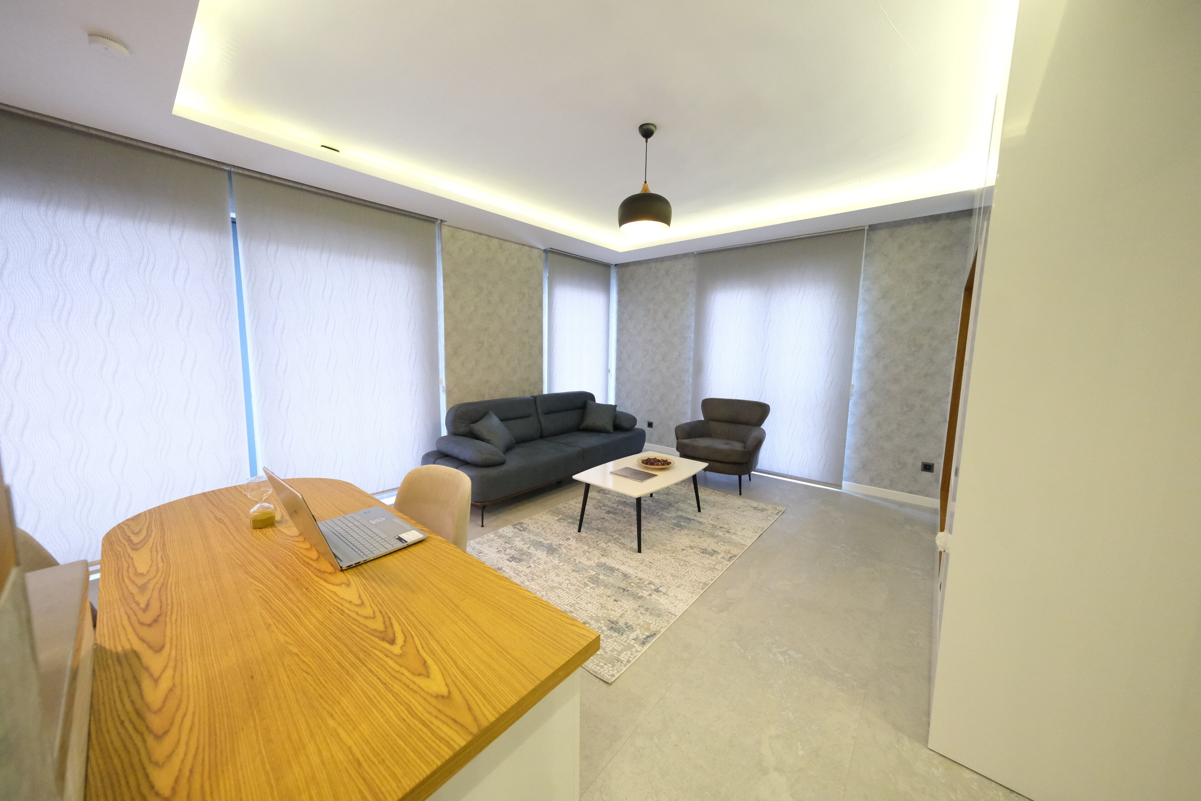 A modern living room with a sofa, armchair, and coffee table.