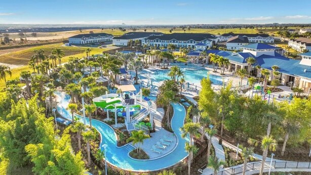 Un resort con diverse piscine, uno scivolo acquatico e un ampio complesso di edifici.
