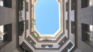 A high-angle view of a building's interior with multiple floors and large windows. - Stunning studio with lift - Louvre (Paris)