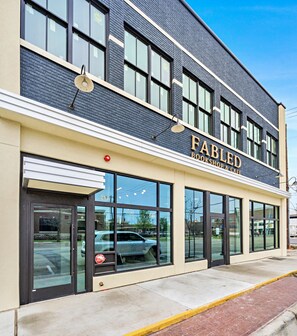 Stunning two-story building with a modern design, featuring large windows and a glass entrance.