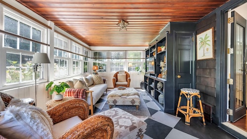 Beautiful cottage on meticulously maintained lawn, surrounded by...