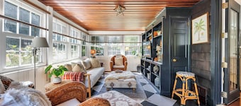 Beautiful cottage on meticulously maintained lawn, surrounded by...