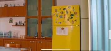Full-size fridge, oven, stovetop, cookware/dishes/utensils