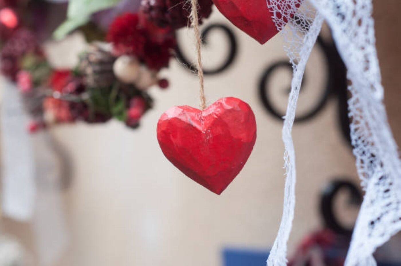 A red heart-shaped ornament hanging from a string.