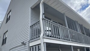 A two-story building with a balcony on the second floor.