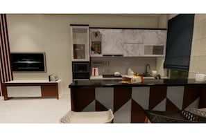 Enjoy cooking in this well-equipped kitchen with a central island, microwave, and range hood.