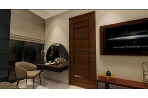 Relax in a stylish room with a large TV, comfortable armchair, and a desk with a lamp and mirror.