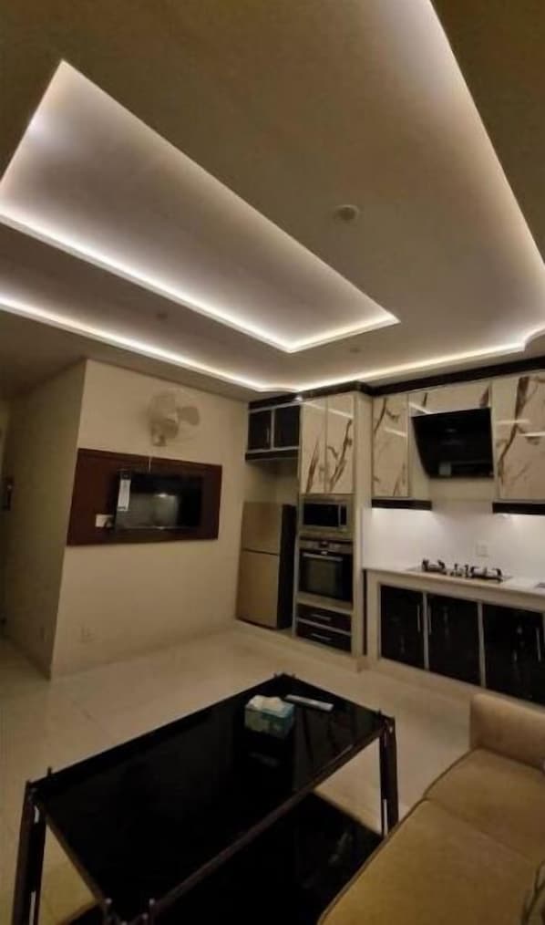 Enjoy a modern kitchen with appliances, flat-screen TV, and dining area.