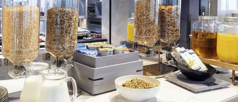 A breakfast buffet with various food items and beverages.