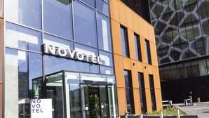 A modern hotel building with a glass facade and a sign reading "NOVOTEL". - Novotel Liverpool Paddington Village (Liverpool)