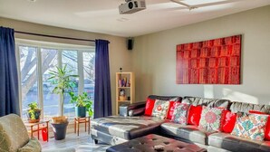 A modern living room with a sofa set, a coffee table, and a bookshelf.