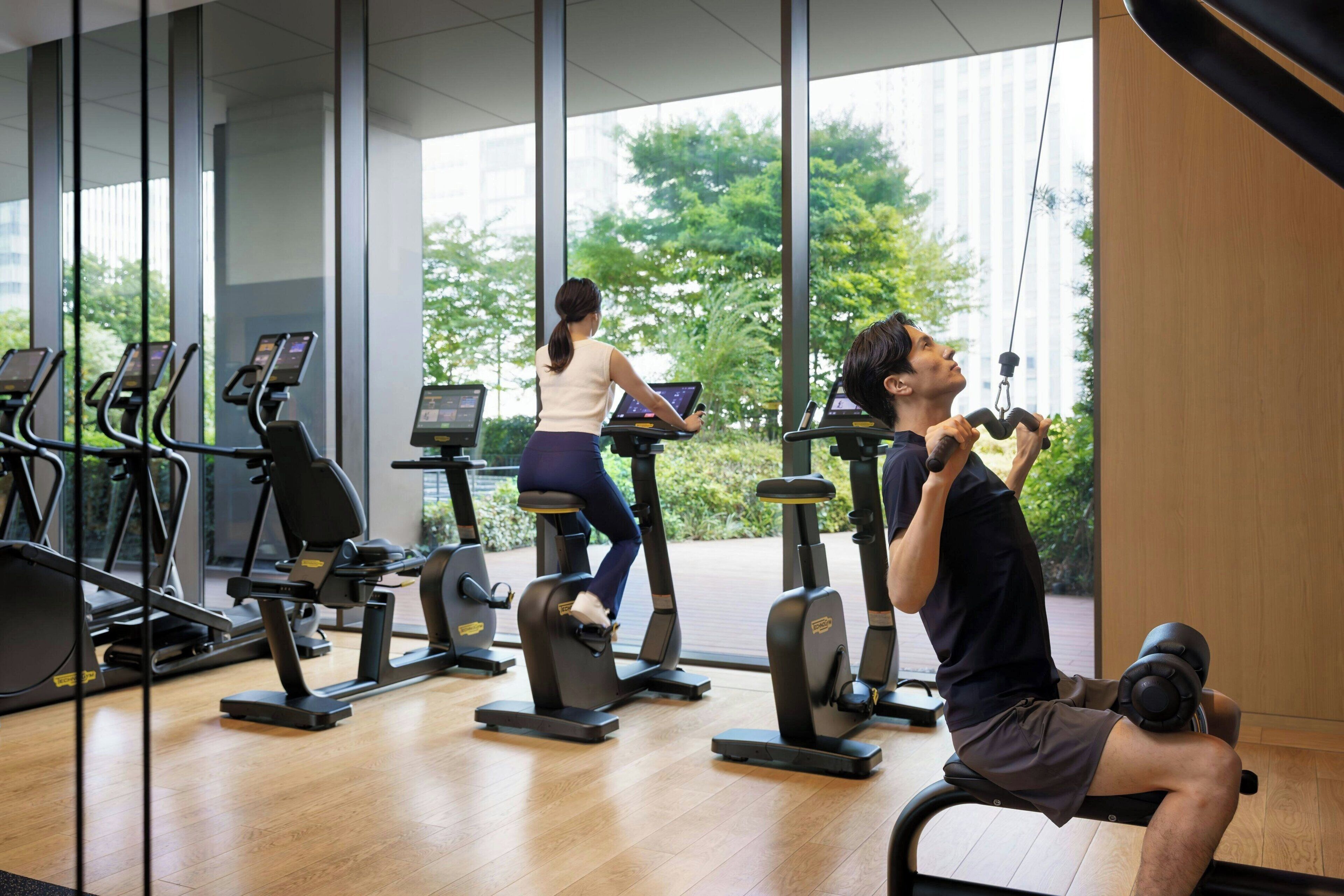 A gym with cardio machines and a rowing machine.