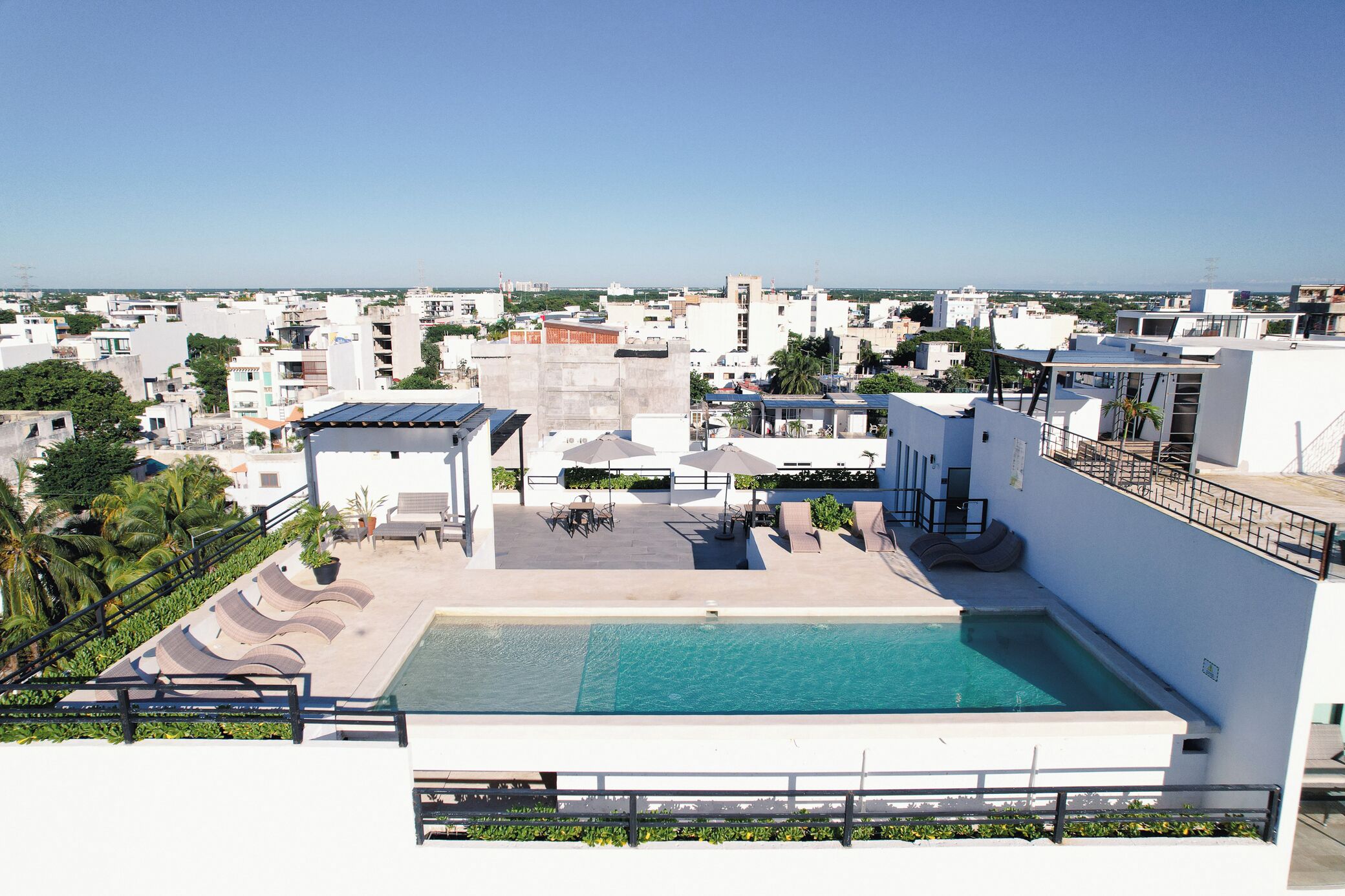 A rooftop pool with a view of the cityscape.
