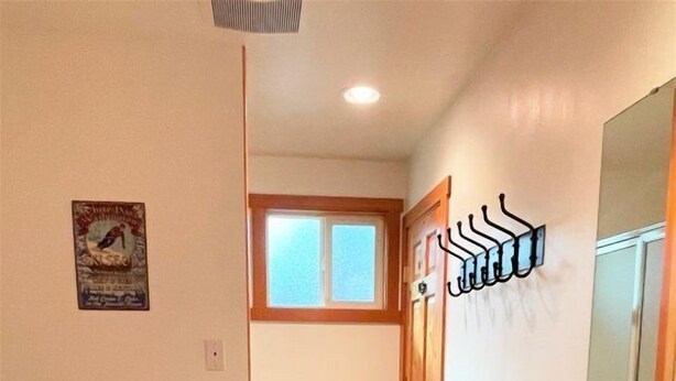 A bathroom with a toilet, sink, and shower area.