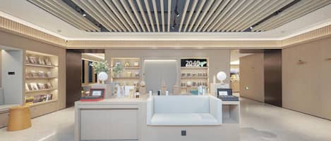 A modern interior with a reception desk, bookshelves, and a 2040 BOOKSTORE sign.