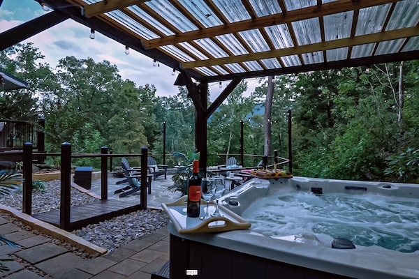 Unwind in the spa-like hot tub or gather by the custom flagstone firepit