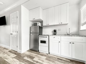 Family Double Room | Private kitchen | Microwave, stovetop, coffee/tea maker, toaster at Neptune Oceanfront Rentals