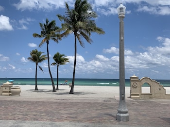 On the beach, sun loungers, beach towels, 2 beach bars at Neptune Oceanfront Rentals