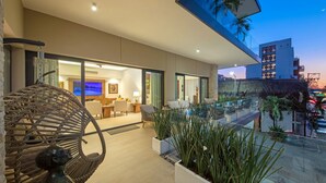 A modern hotel interior with a balcony, seating area, and a view of the cityscape. - Loft 268 "Beautiful Modern Condominium" in  Romantic Zone, Puerto Vallarta. (Puerto Vallarta)