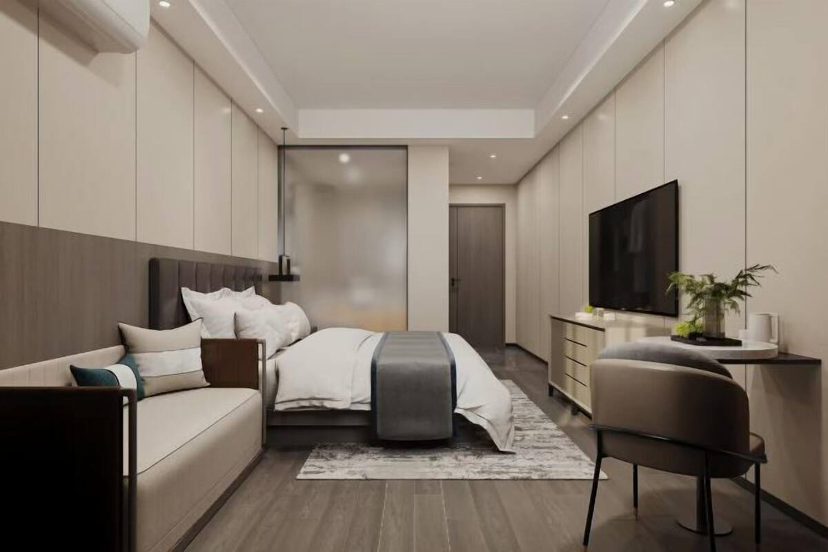 A modern bedroom with a bed, a sofa, a TV, and a desk.
