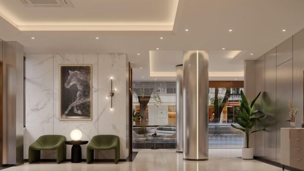 A modern lobby with a marble wall, a large abstract painting, two green chairs, a round table with a light, and a large metallic pillar. - Laiyueke Hotel (Shenzhen)