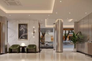 A modern lobby with a marble wall, a large abstract painting, two green chairs, a round table with a light, and a large metallic pillar. - Laiyueke Hotel (Shenzhen)