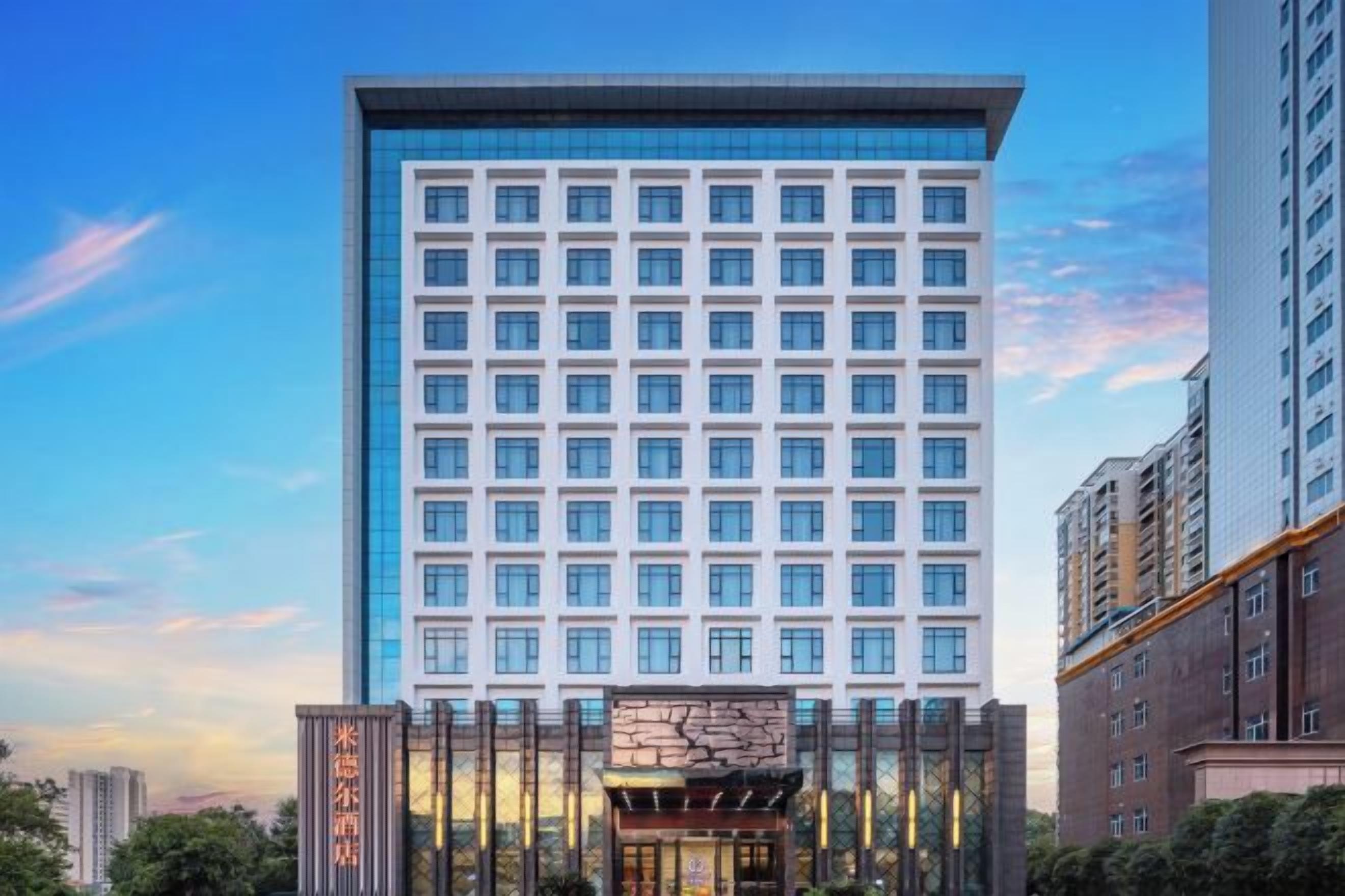 A high-rise hotel with a modern facade, multiple floors, and a prominent entrance.