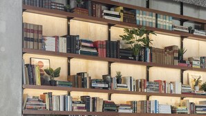 A cozy living area with a bookshelf, a sofa, and a coffee table. - YUST Liège (Liege)