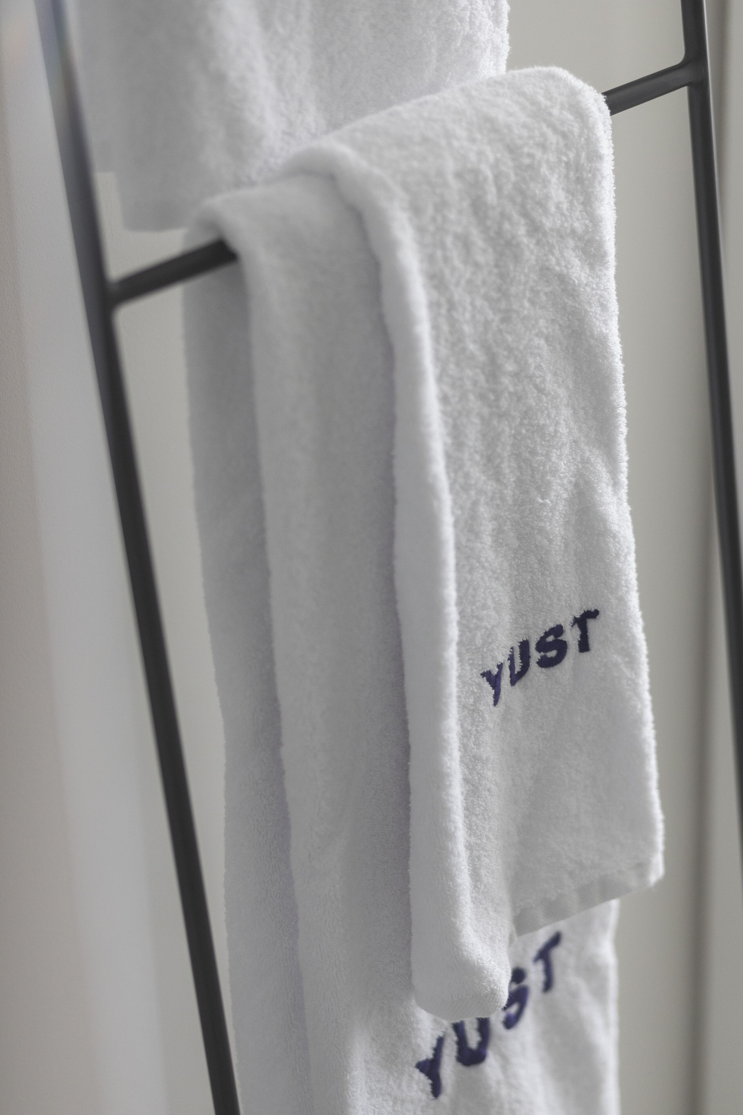 shower, hair dryer, towels, toilet paper