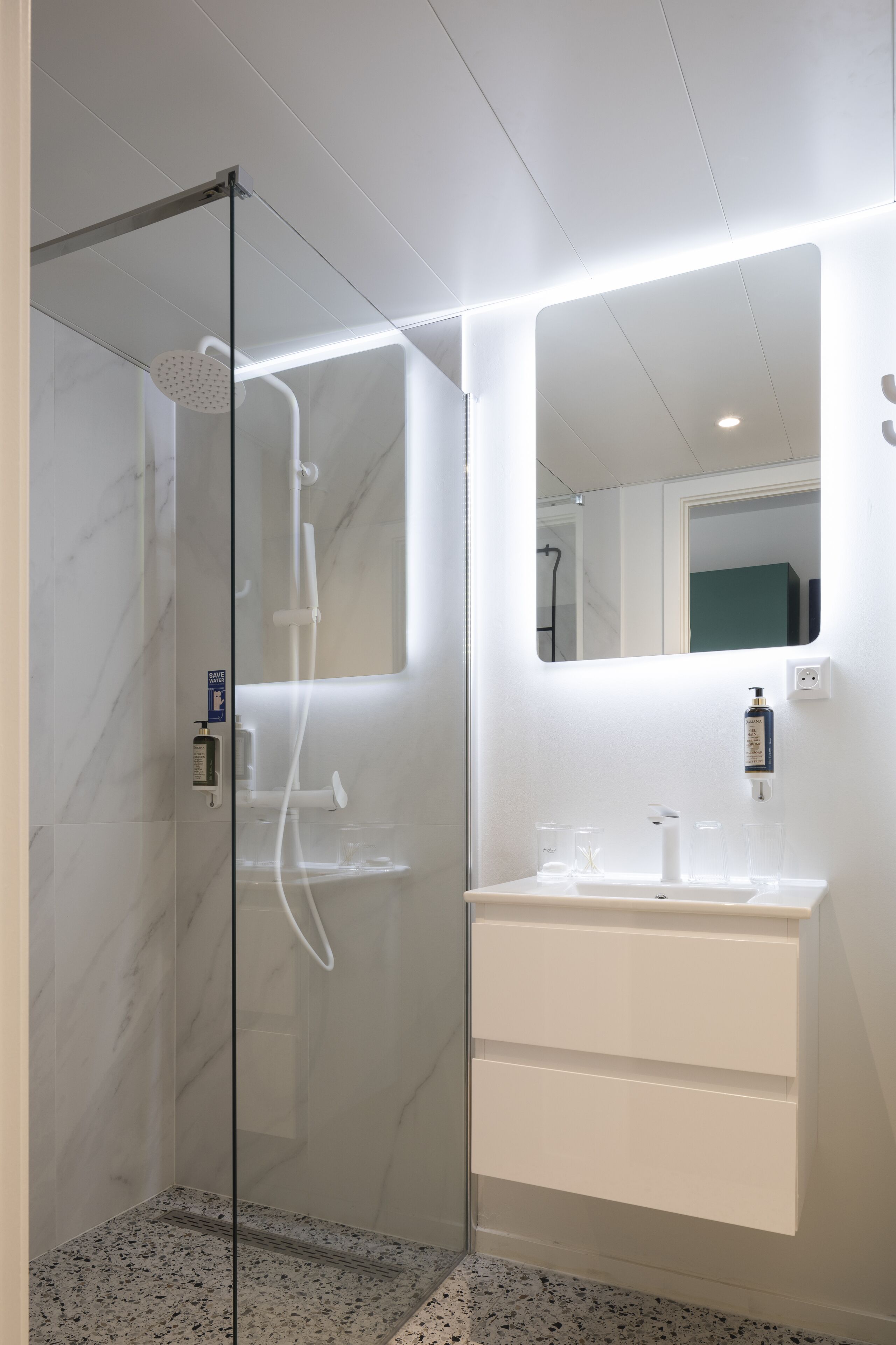 shower, hair dryer, towels, toilet paper