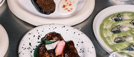 A variety of dishes on plates, suggesting a dining setting.